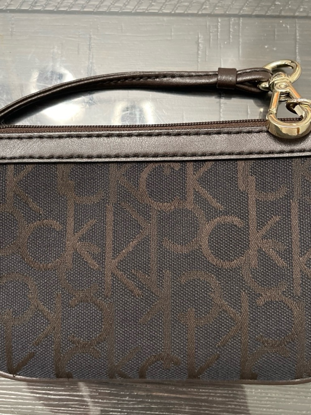 Calvin Klein Dark Brown Monogram Wristlet with Gold Hardware